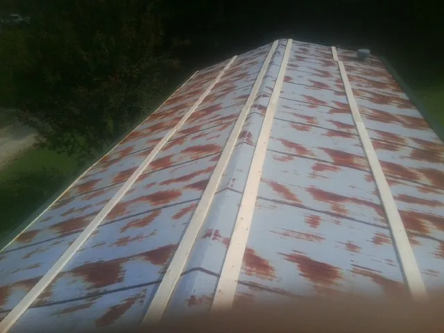 Rusted metal roof panels with new wood purlins before replacement — Storm Damage Roof Repair in Wilberforce by Roofing Brothers
