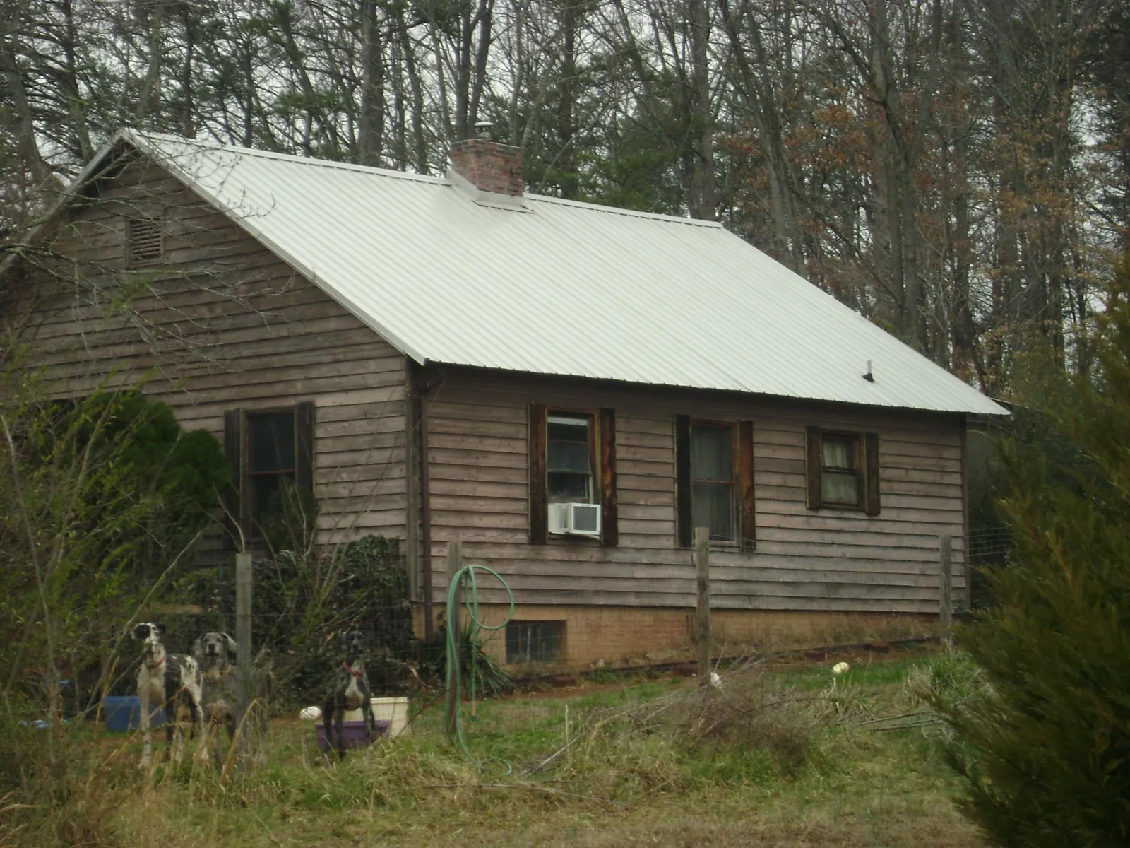 White metal roof on an old wood sided farmhouse, from a Metal Roof Installation job in Wilberforce